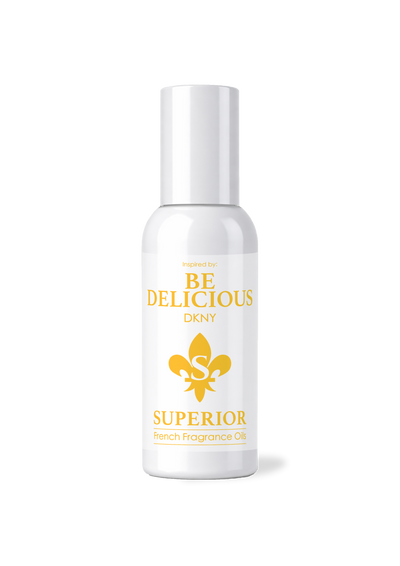 White bottle of 'Be Delicious' perfume with gold text and logo on a white background